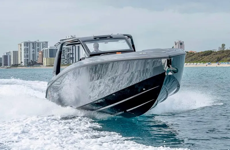 Slide: The Image of 2023 Cigarette 41 Nighthawk speedboat cruising on water near city skyline. - 9