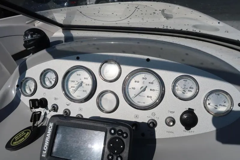 Slide: The Image of Dashboard of a 2009 Bayliner 215 BR boat with gauges and Lowrance device. - 15