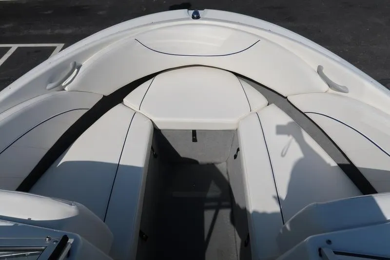 Slide: The Image of 2009 Bayliner 215 BR boat interior with white seating and spacious layout. - 17