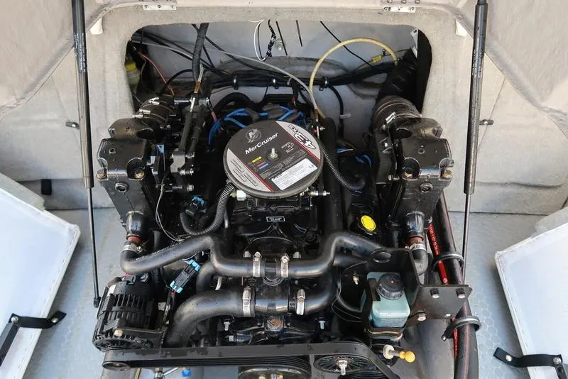 Slide: The Image of Engine compartment of a 2009 Bayliner 215 BR boat, featuring a MerCruiser engine. - 3