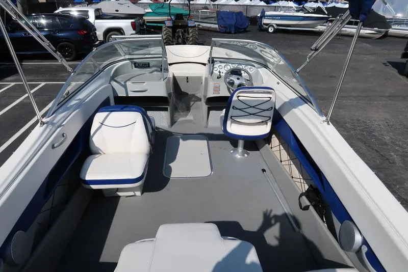 Slide: The Image of 2009 Bayliner 215 BR boat interior with seating and steering wheel. - 7