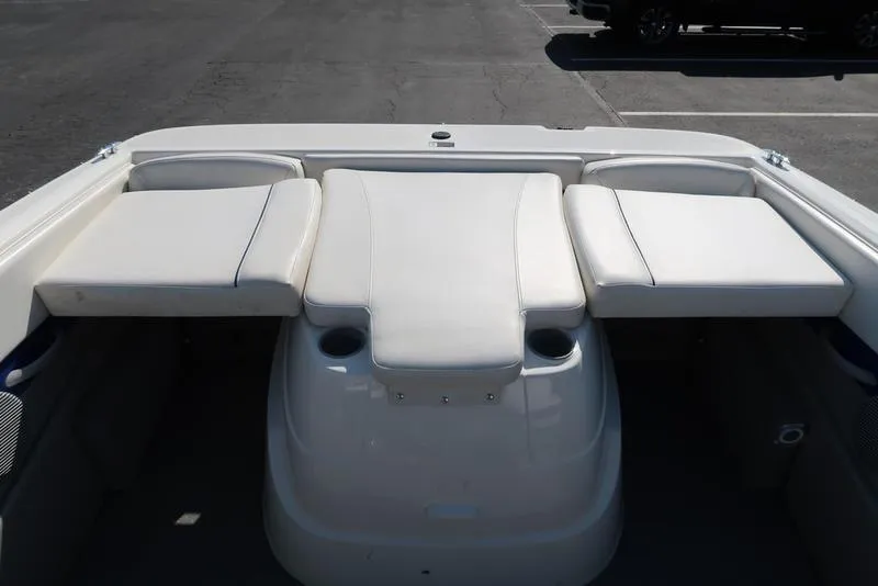 Slide: The Image of 2009 Bayliner 215 BR boat interior with white cushioned seating. - 9