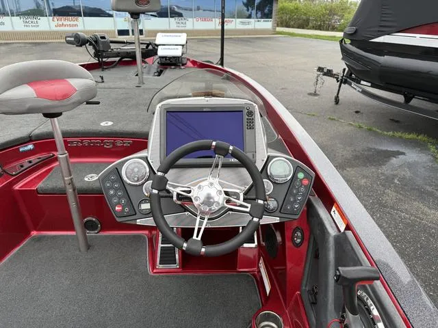 Slide: The Image of 2015 Ranger Z520C boat dashboard with steering wheel and electronic display. - 4