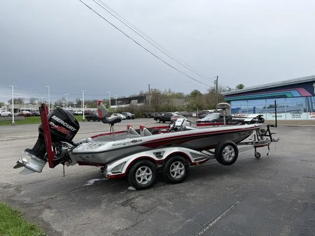 Slide: The Image of 2015 Ranger Z520C bass boat with Mercury engine on a trailer in a parking lot. - 5