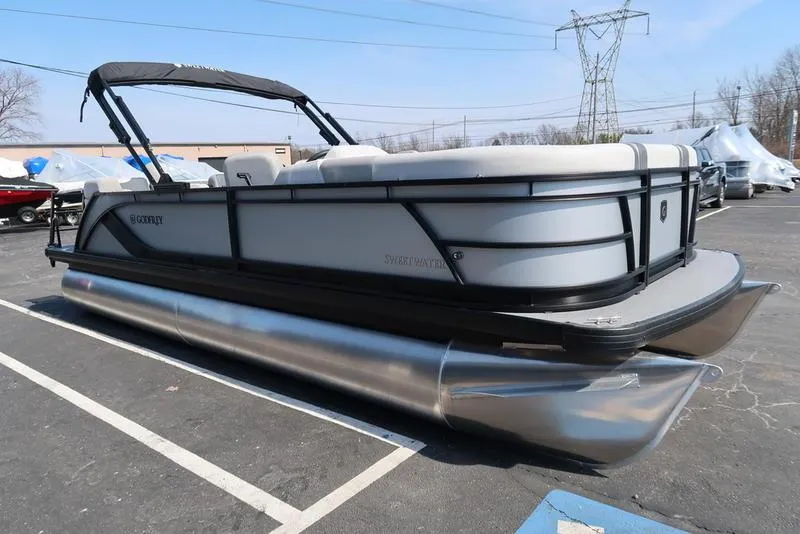 Slide: The Image of 2025 Godfrey Sweetwater 2286 QS pontoon boat in parking lot, side view. - 12
