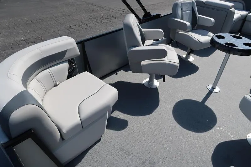 Slide: The Image of 2025 Godfrey Sweetwater 2286 QS pontoon boat interior with plush seating and table. - 15