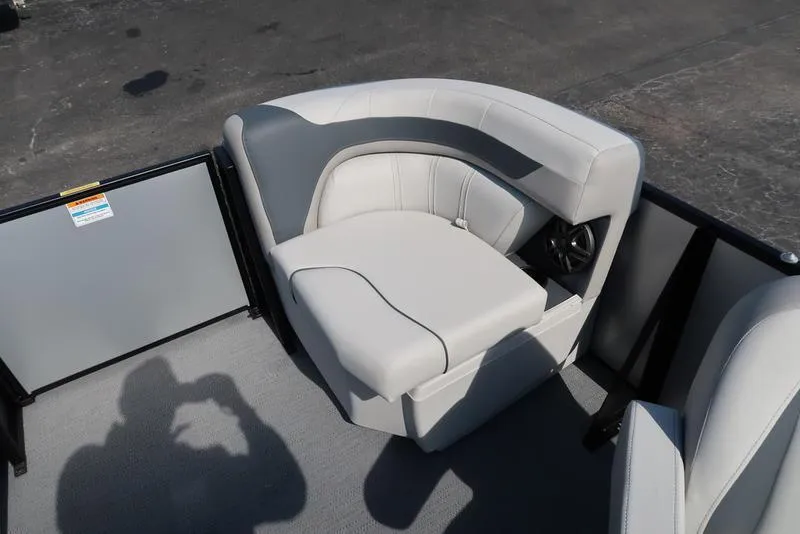 Slide: The Image of 2025 Godfrey Sweetwater 2286 QS boat interior with plush seating and speaker. - 16