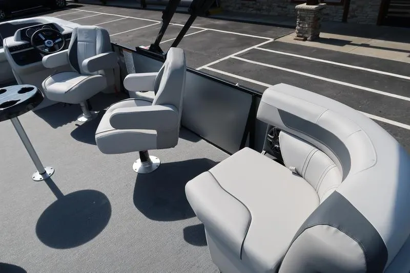 Slide: The Image of 2025 Godfrey Sweetwater 2286 QS pontoon boat interior with plush seating and steering console. - 17