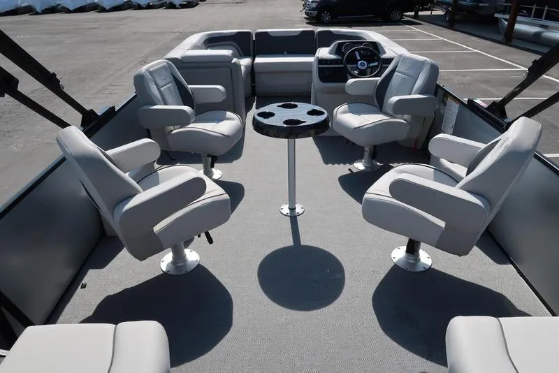 Slide: The Image of 2025 Godfrey Sweetwater 2286 QS pontoon boat interior with plush seating and central table. - 18