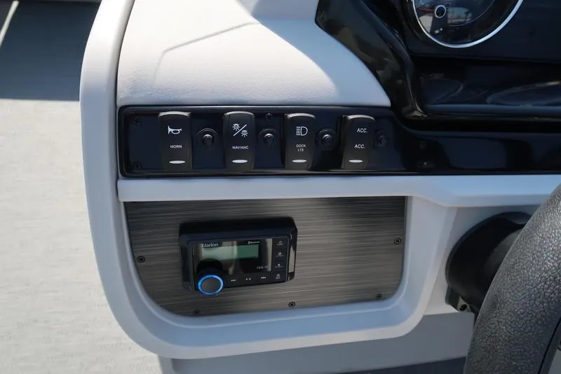 Slide: The Image of Control panel of 2025 Godfrey Sweetwater 2286 QS boat with switches and stereo system. - 19