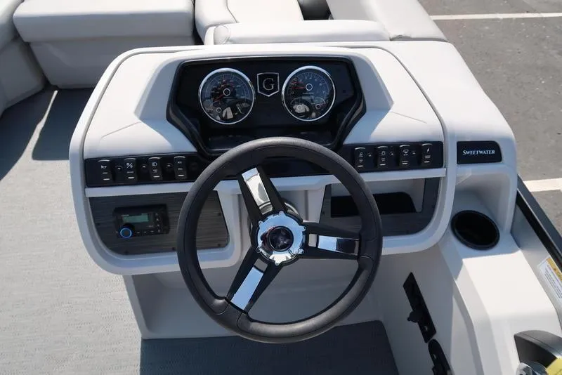Slide: The Image of Steering console of 2025 Godfrey Sweetwater 2286 QS boat with gauges and controls. - 21