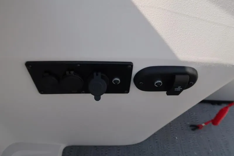 Slide: The Image of Control panel on 2025 Godfrey Sweetwater 2286 QS boat, featuring switches and outlets. - 25