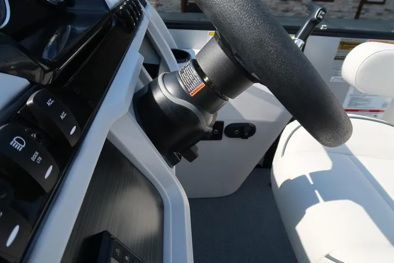 Slide: The Image of Steering wheel and controls of 2025 Godfrey Sweetwater 2286 QS boat. - 26