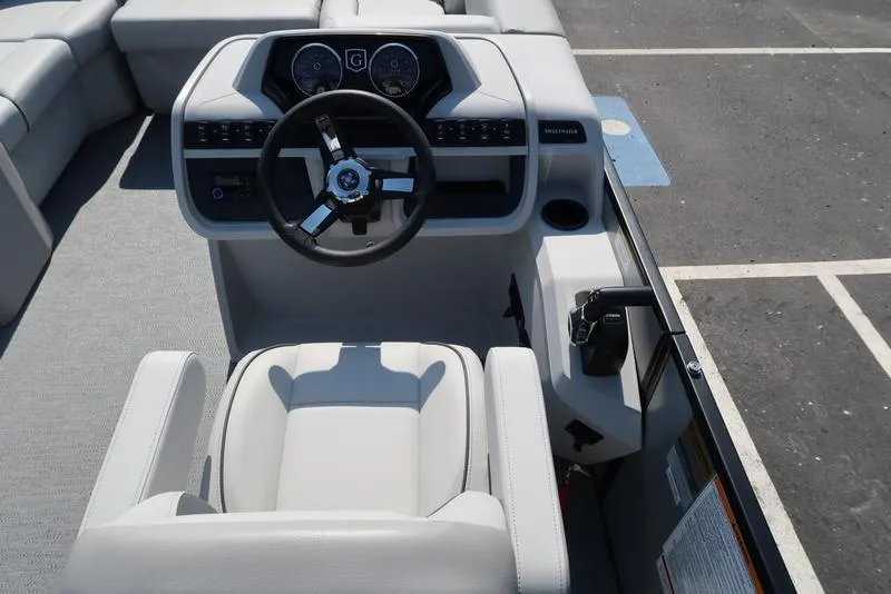 Slide: The Image of 2025 Godfrey Sweetwater 2286 QS boat helm with modern steering and controls. - 30