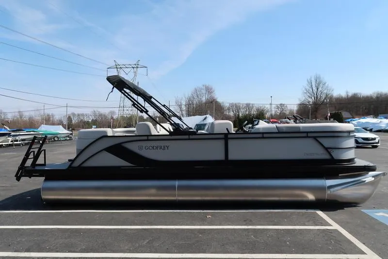 Slide: The Image of 2025 Godfrey Sweetwater 2286 QS pontoon boat parked outdoors on a sunny day. - 9