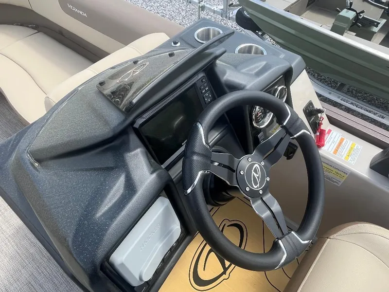 Slide: The Image of 2025 Veranda Relax VR22RC boat dashboard with steering wheel and control panel. - 10