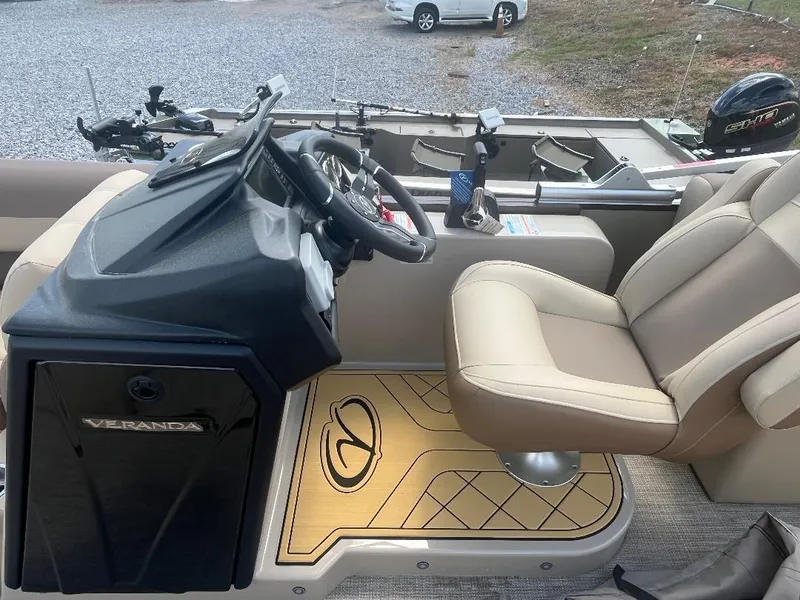 Slide: The Image of 2025 Veranda Relax VR22RC boat interior with beige seating and modern dashboard. - 11
