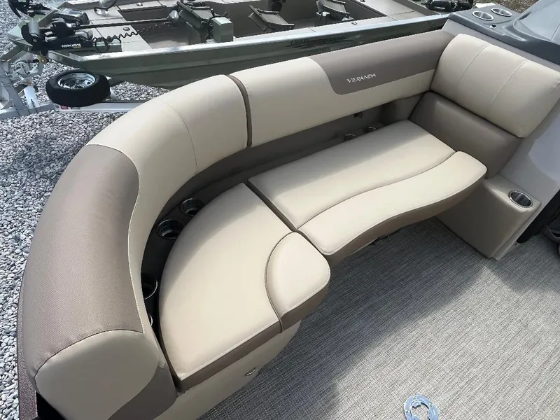 Slide: The Image of 2025 Veranda Relax VR22RC boat with beige and brown cushioned seating. - 12