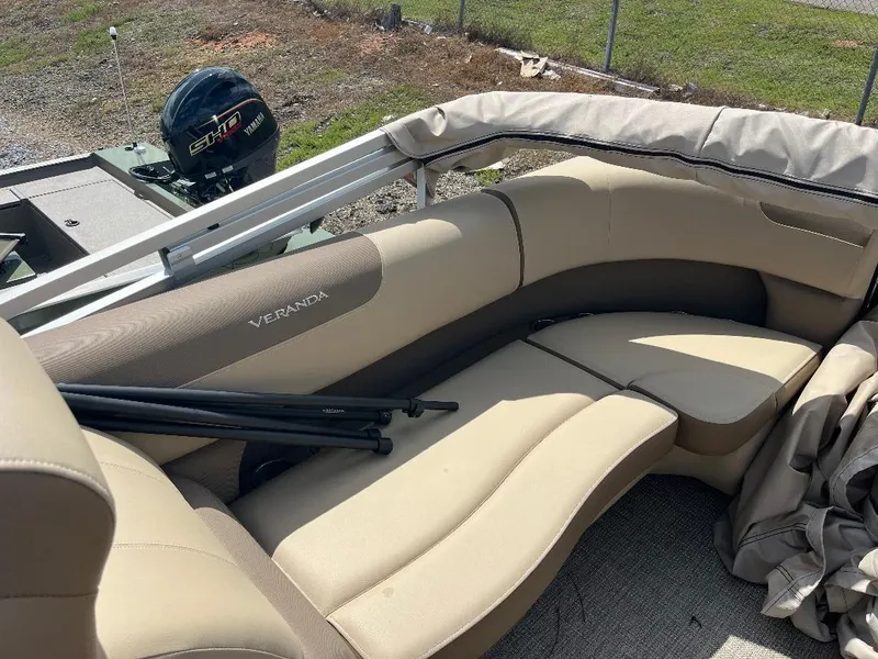 Slide: The Image of 2025 Veranda Relax VR22RC boat interior with beige seating and outdoor motor. - 8