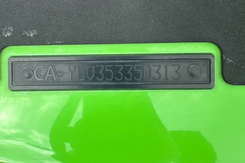 Slide: The Image of 2013 Sea-Doo GTI SE 130 hull identification number on green surface. - 11