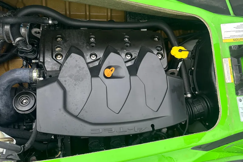 Slide: The Image of Engine compartment of a 2013 Sea-Doo GTI SE 130, featuring a green exterior. - 9
