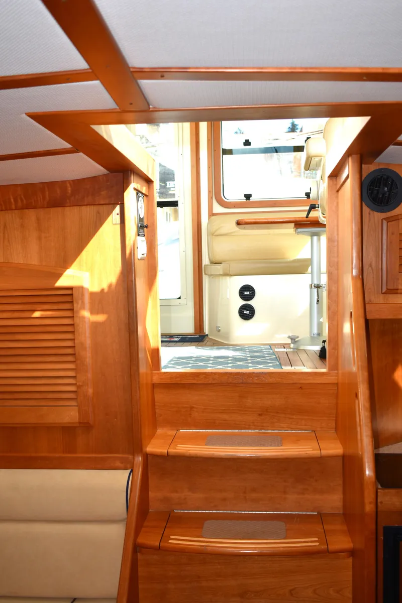 Slide: The Image of 2007 Sabre 38 Hardtop Express interior with wooden stairs and bright natural lighting. - 15