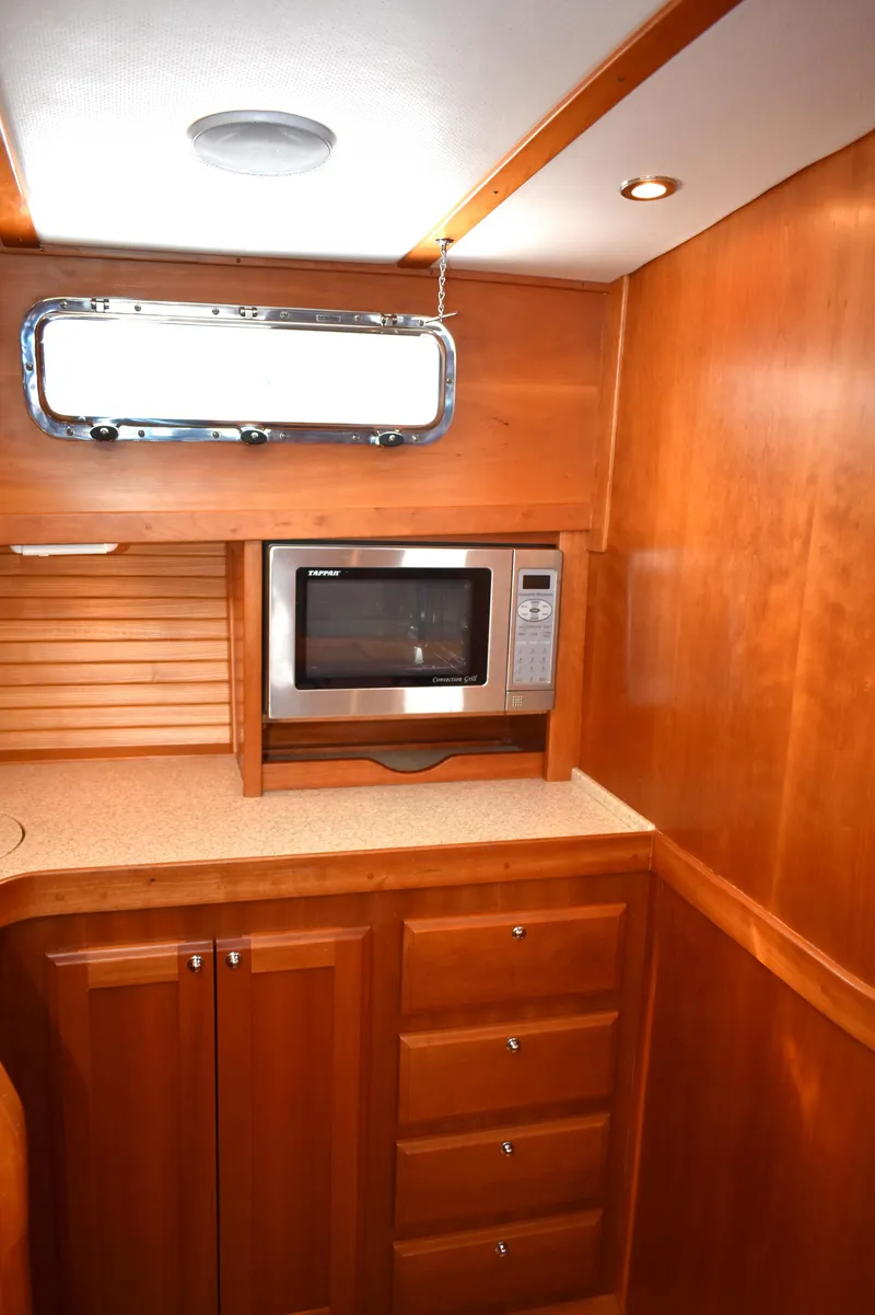 Slide: The Image of 2007 Sabre 38 Hardtop Express galley with wood cabinetry and built-in microwave. - 17