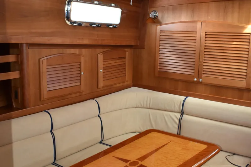 Slide: The Image of Interior of 2007 Sabre 38 Hardtop Express with wood paneling and cushioned seating. - 18