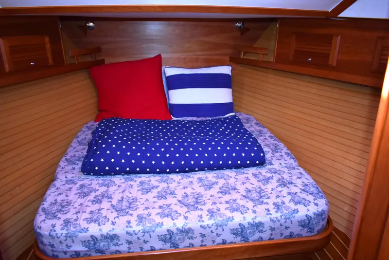 Slide: The Image of Cozy cabin bed in 2007 Sabre 38 Hardtop Express with colorful bedding. - 21