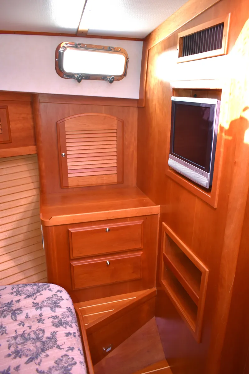 Slide: The Image of 2007 Sabre 38 Hardtop Express cabin interior with wood cabinetry and built-in TV. - 22
