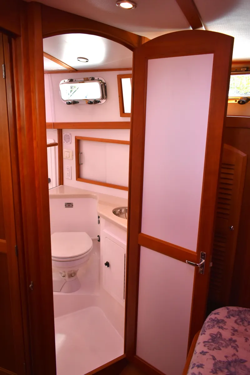Slide: The Image of 2007 Sabre 38 Hardtop Express bathroom with wooden door and compact design. - 25