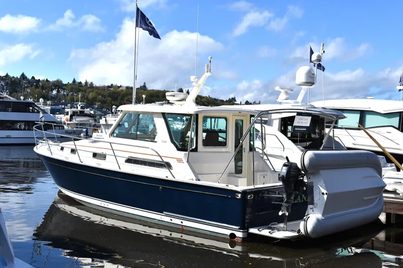 Slide: The Image of 2007 Sabre 38 Hardtop Express yacht docked at marina, featuring sleek design and blue hull. - 29