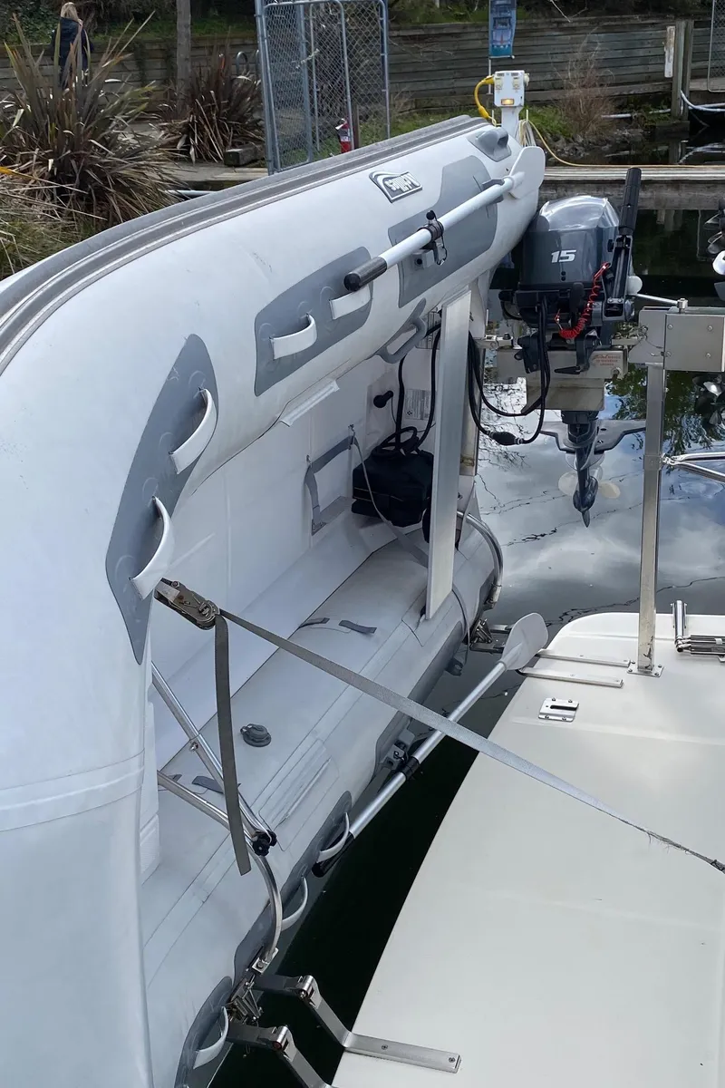 Slide: The Image of 2007 Sabre 38 Hardtop Express with attached dinghy and outboard motor at dock. - 31