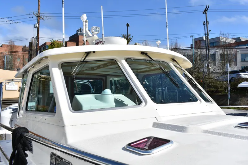 Slide: The Image of 2007 Sabre 38 Hardtop Express boat with sleek white exterior and modern design. - 5