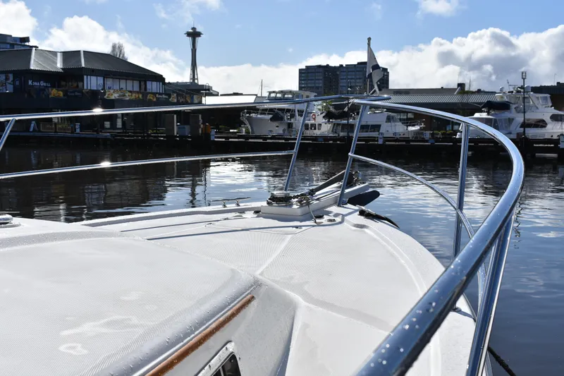 Slide: The Image of 2007 Sabre 38 Hardtop Express yacht docked in a marina with cityscape background. - 6
