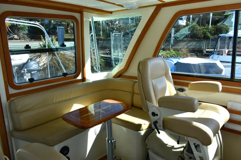 Slide: The Image of Interior of 2007 Sabre 38 Hardtop Express with beige seating and wooden table. - 9