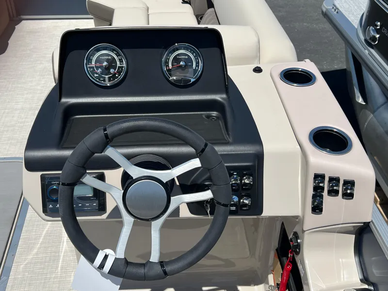Slide: The Image of 2024 Harris FloteBote Sunliner 230 dashboard with steering wheel and gauges. - 13