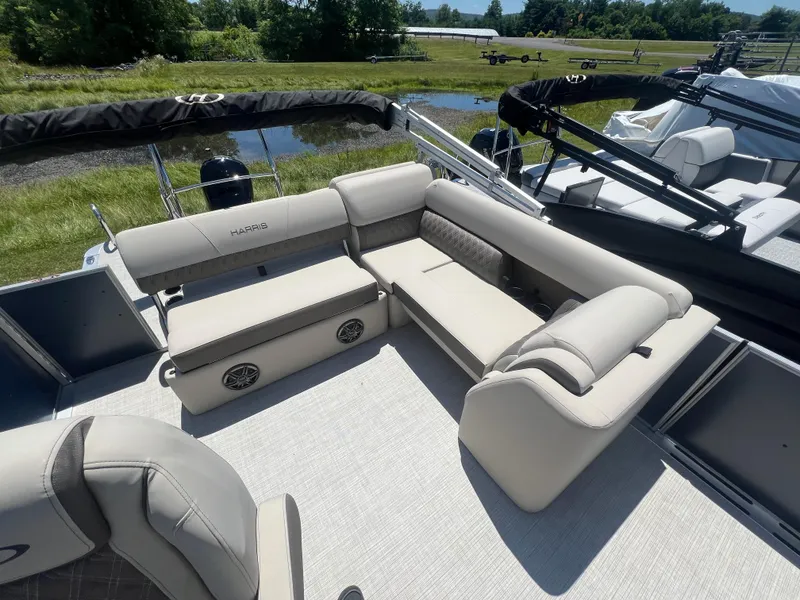 Slide: The Image of 2024 Harris FloteBote Sunliner 230 pontoon boat with beige seating and spacious deck. - 14