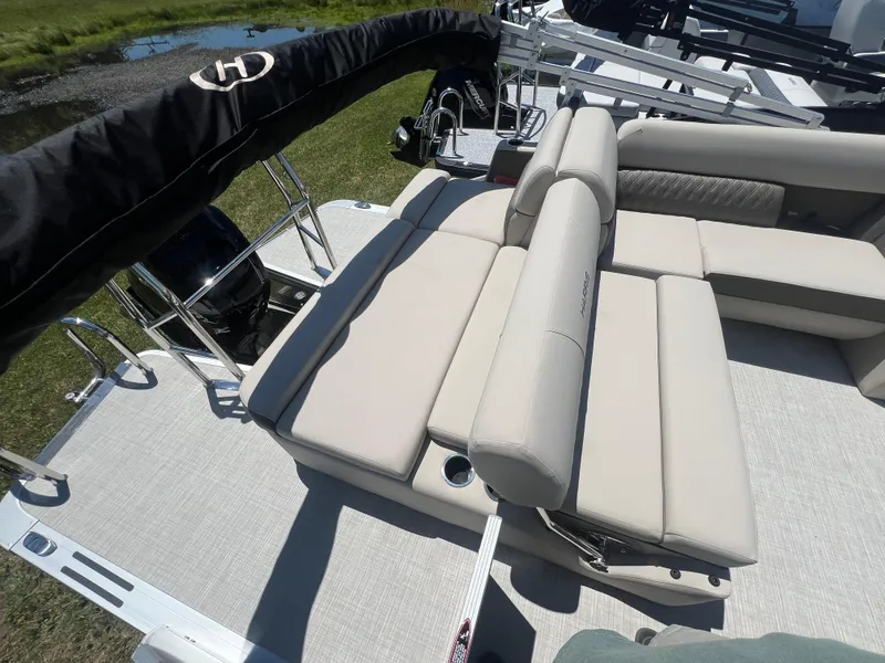 Slide: The Image of 2024 Harris FloteBote Sunliner 230 pontoon boat with beige seating and sleek design. - 15