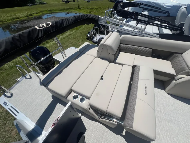Slide: The Image of 2024 Harris FloteBote Sunliner 230 pontoon boat with luxurious seating and sleek design. - 16