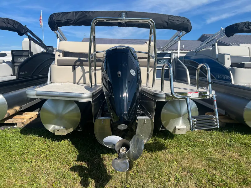 Slide: The Image of 2024 Harris FloteBote Sunliner 230 pontoon boat with outboard motor, displayed on grass. - 19
