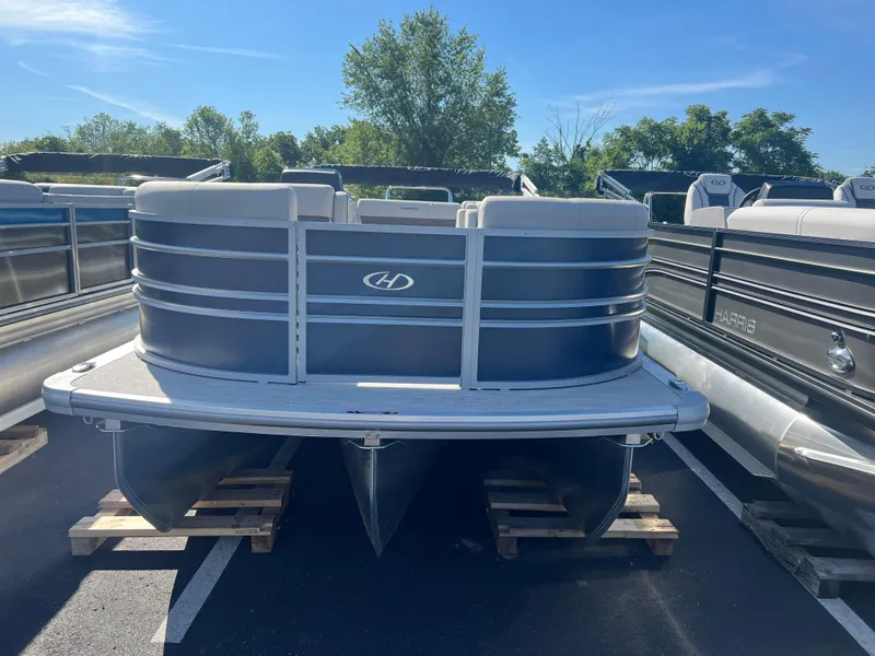 Slide: The Image of 2024 Harris FloteBote Sunliner 230 pontoon boat on display in a parking lot. - 21