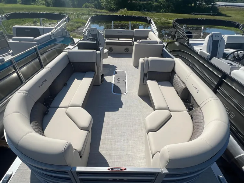 Slide: The Image of 2024 Harris FloteBote Sunliner 230 pontoon boat with spacious seating and modern design. - 22