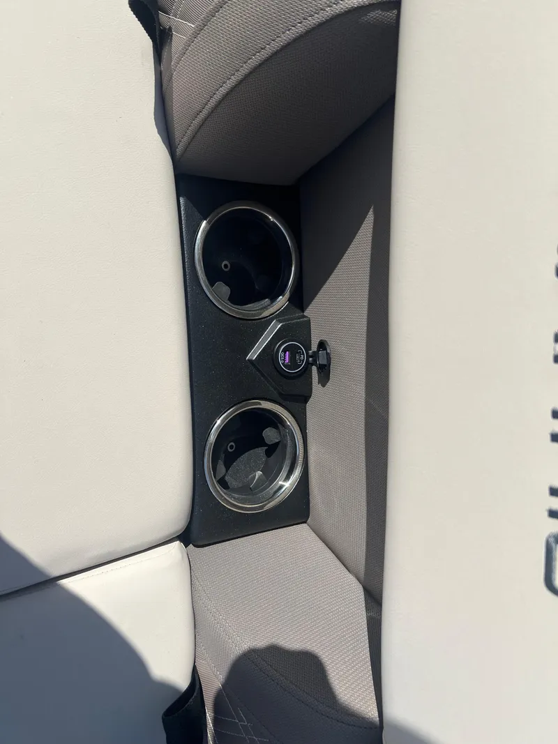 Slide: The Image of 2024 Harris FloteBote Sunliner 230 cup holders and USB port on beige seating. - 3