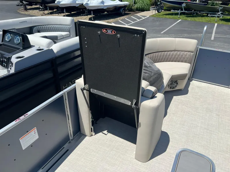 Slide: The Image of 2024 Harris FloteBote Sunliner 230 interior with seating and storage compartment. - 8