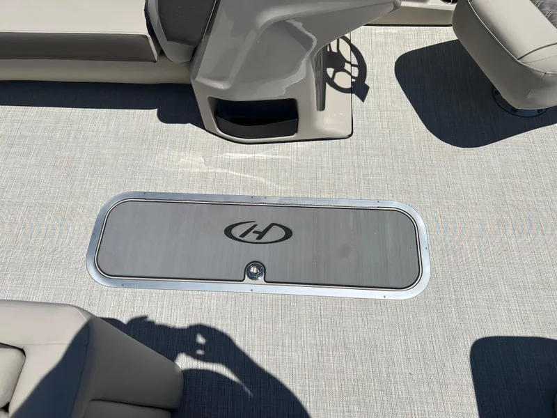 Slide: The Image of 2024 Harris FloteBote Sunliner 230 interior flooring with storage compartment. - 9