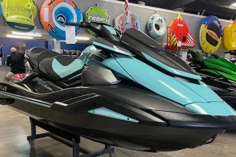 Slide: The Image of 2022 Yamaha WaveRunner FX Cruiser HO in showroom, surrounded by colorful water sports gear. - 1