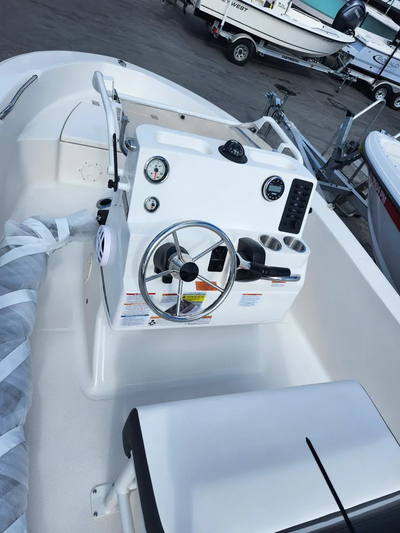 Slide: The Image of 2025 Robalo R160 boat cockpit with steering wheel and control panel. - 5
