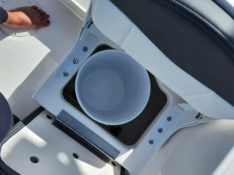 Slide: The Image of 2025 Robalo R160 boat interior with storage compartment and bucket. - 6