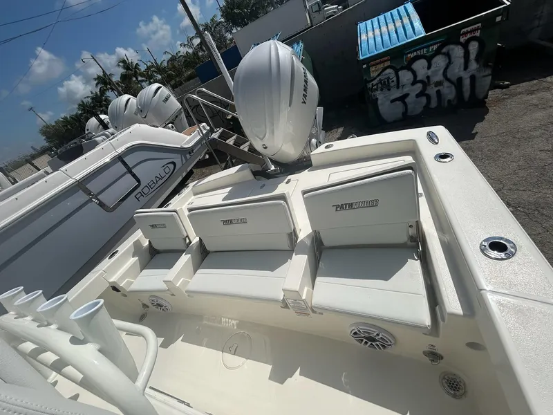 Slide: The Image of 2025 Pathfinder 2600 TRS boat interior with seating and Yamaha outboard motor. - 5